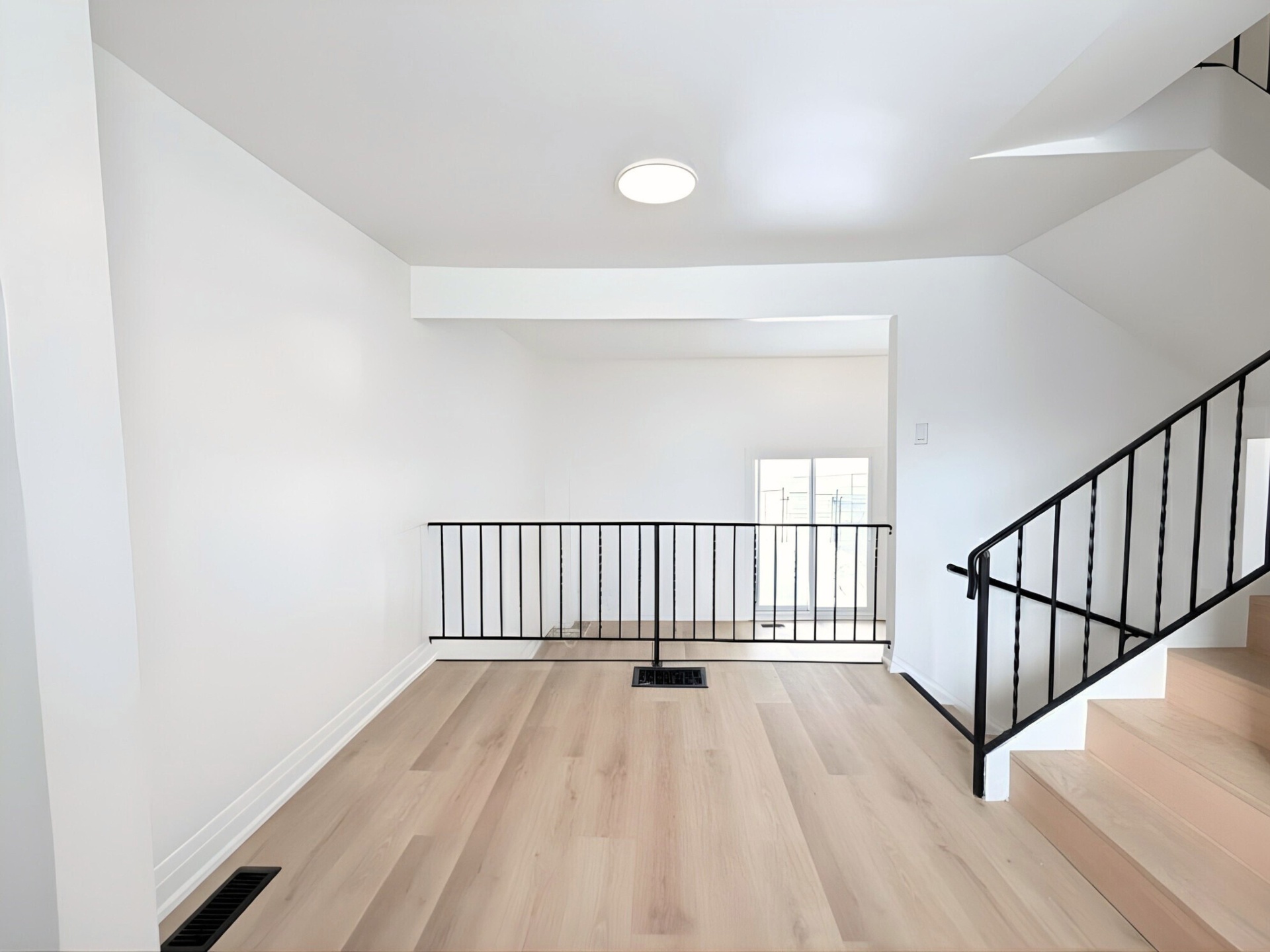 Second-floor landing with iron railings